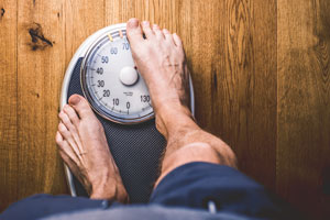 Person standing on scales; one foot covers half of the display 