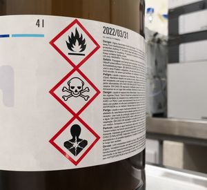 Bottle labelled with three hazardous substances symbols.