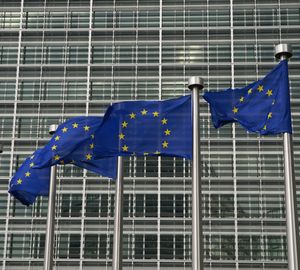 Several flagpoles with EU flags