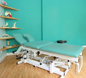 Height-adjustable treatment table