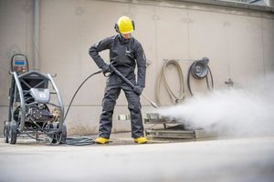 Man in protective clothing working with a high-pressure water spray gun