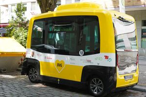 Self-driving minibus standing at the side of the road