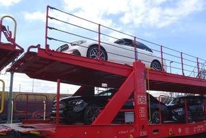 Double-decker car transporter during loading and unloading, with barrier raised