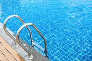 Entering a swimming pool via a ladder