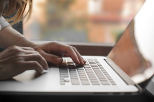 Woman working on a laptop.