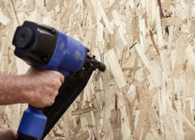 Carpenter using a nail gun