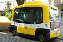Self-driving minibus standing at the side of the road